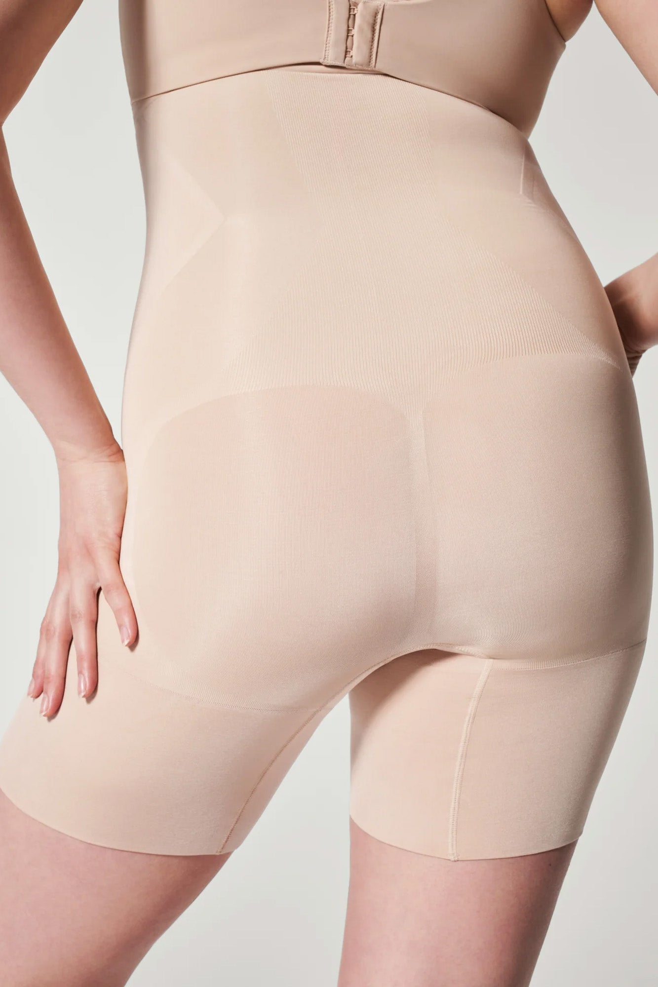 The Oncore High-Waisted Mid-Thigh Short By Spanx In Soft Nude - GINIA